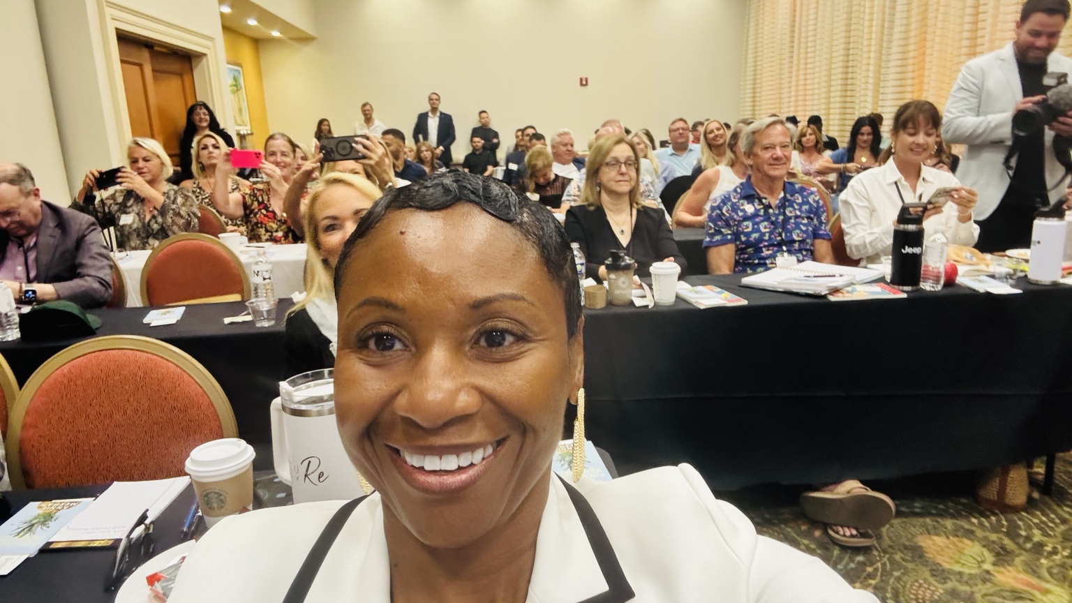 Felisha D. McCaskill smiling with a community of women